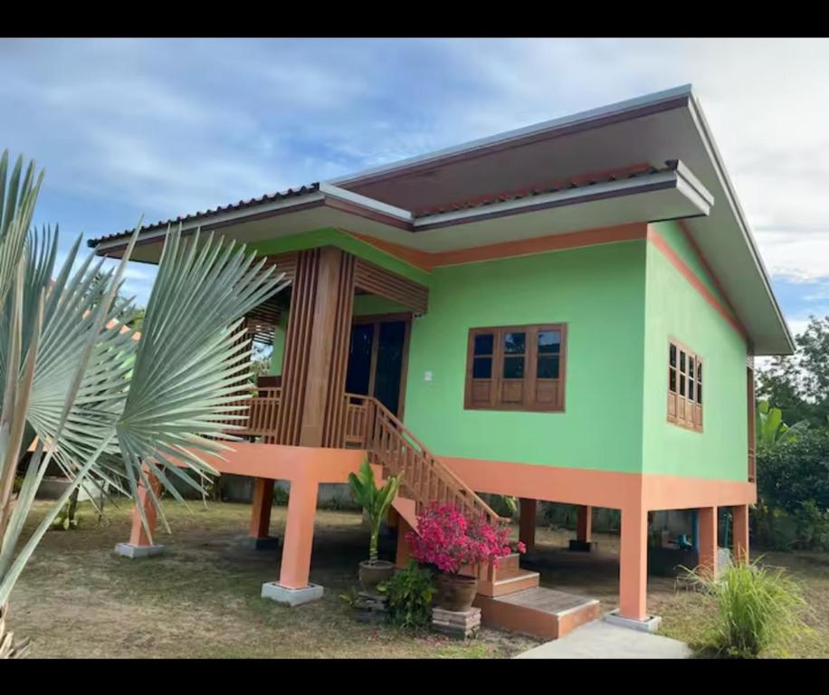a small house with a green at Srisook House in Ko Phangan