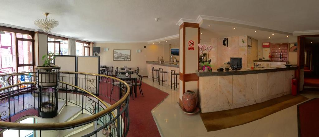 a large room with a counter and a kitchen at Hotel La Ronda in Castro-Urdiales