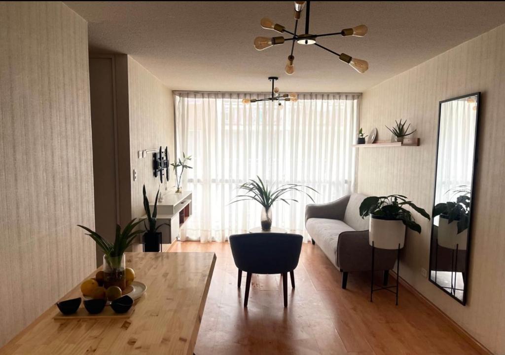 a living room with a couch and a table at Acogedora habitación in Lima