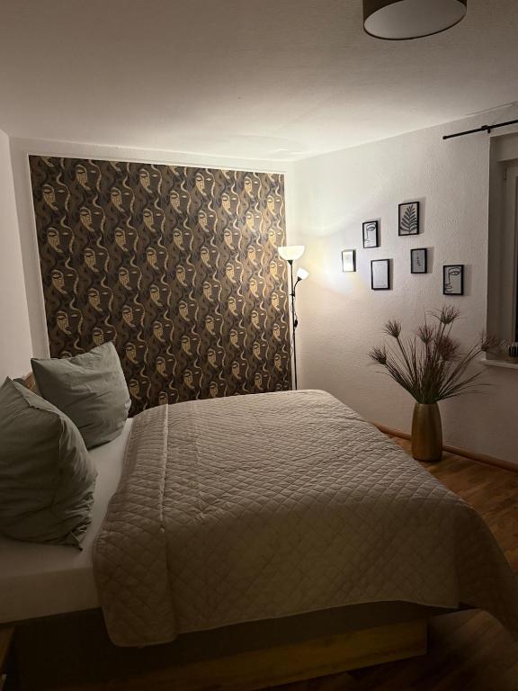 a bedroom with a bed and a wall with pictures at Ferienwohnung am Senftenberger See - Wohnung 2 in Senftenberg