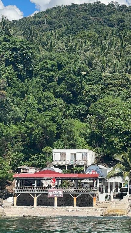 a train on a bridge over a body of water at Kantil Dive Resort in Batangas City