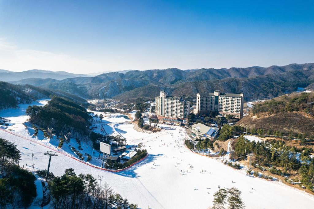 an aerial view of a city with a snow covered beach at OakValley Resort Hills Village in Wonju