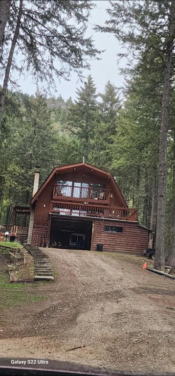 a large wooden house in the middle of a forest at Brown Family Farm in Grand Forks