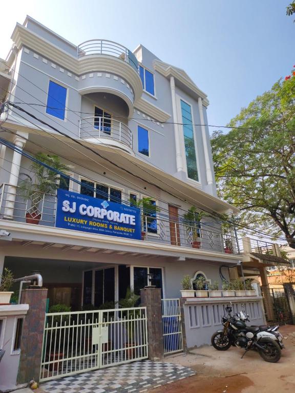 a building with a motorcycle parked in front of it at Hotel SJ corporate in Bhubaneshwar