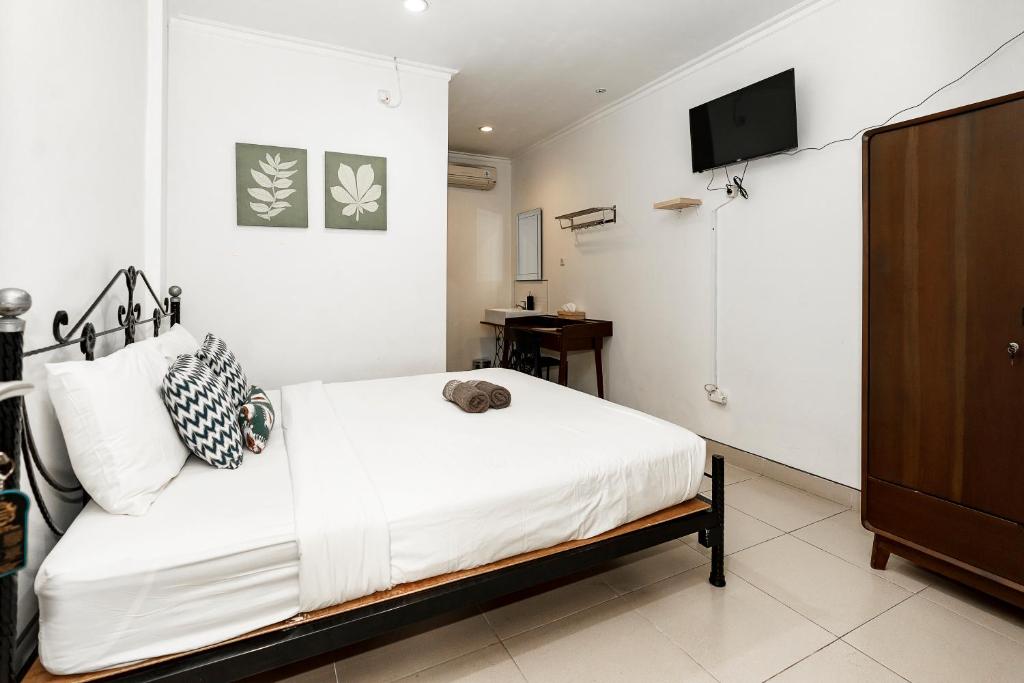 Postel nebo postele na pokoji v ubytování Wisma Eyang Sosro