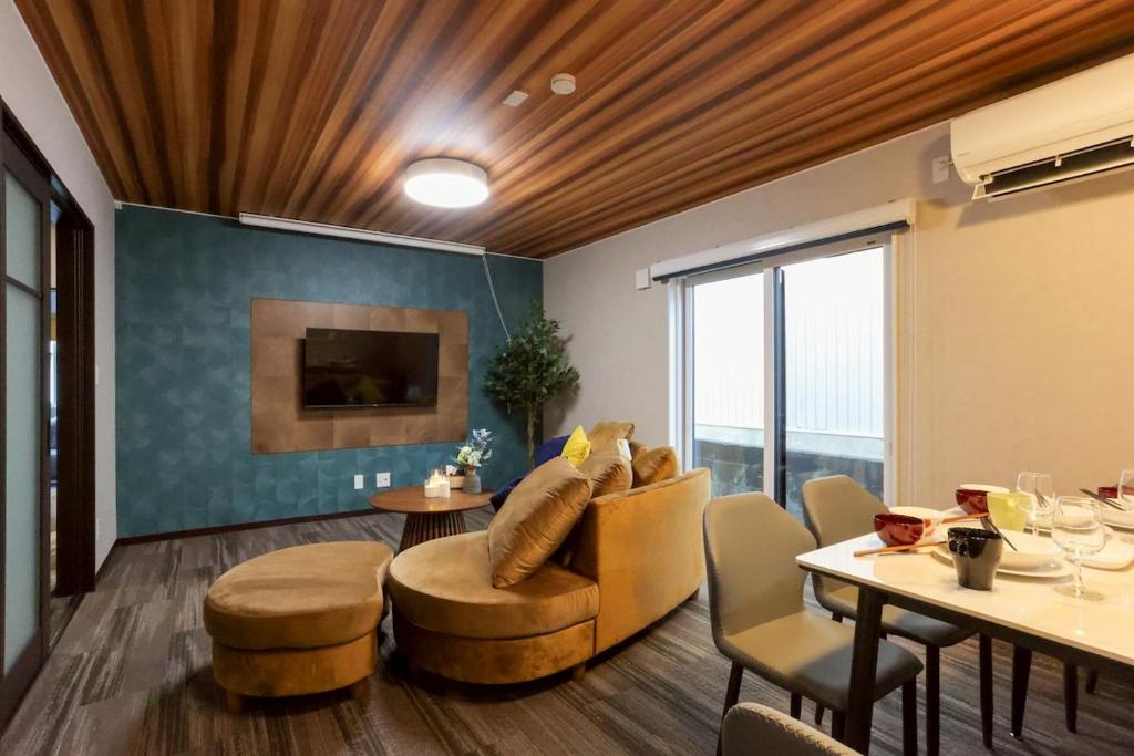 a living room with a couch and a table and chairs at Pine21 TOHOKU 