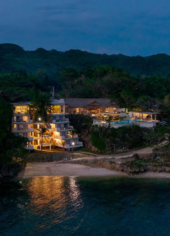 an aerial view of a resort at night at Solea Reef Resort Anda in Anda