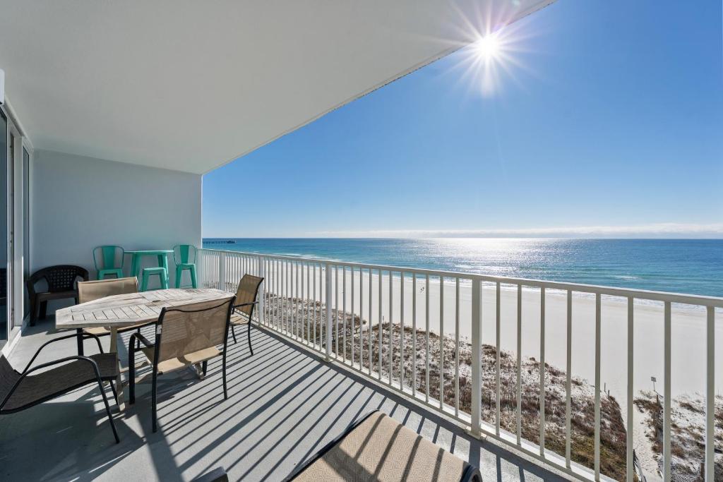 a balcony with a table and chairs and the ocean at Lighthouse 714 in Gulf Shores