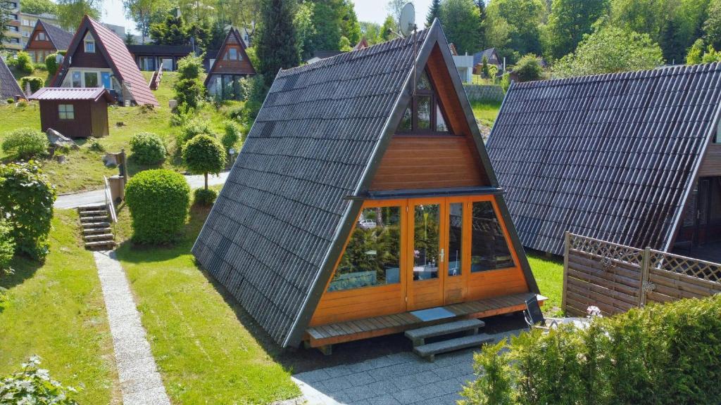 a small house with a metal roof on a yard at Haus Sternenblick 22 in Freyung