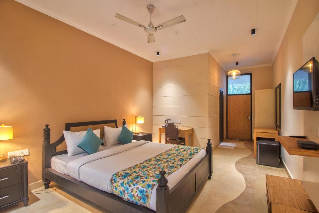 a bedroom with a large bed and a desk at Aruba Luxury Resort By AADI Hospitality in Morjim
