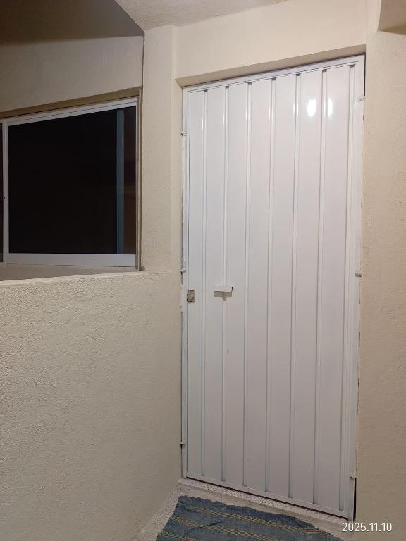 a room with a closet and a window and a door at Apartamentos Turiksa in Acapulco