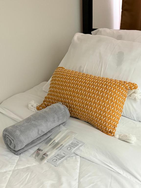 a blanket and a thermometer on a bed at 2BR Condo Near IT Park and Malls in Mandaue City