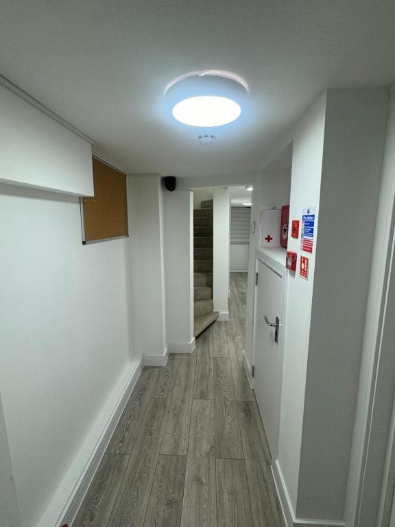 an empty room with a hallway with a light on the ceiling at Systematic Home in Battlesbridge