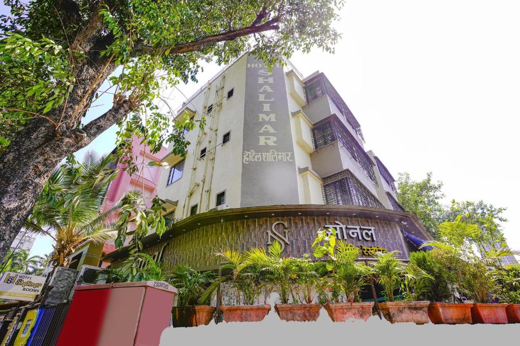 a building with a sign in front of it at Hotel O Shalimar in Mumbai