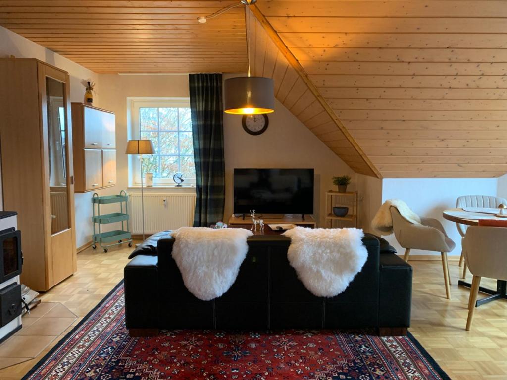 a living room with a black couch and a table at Mein Sauerland in Medebach