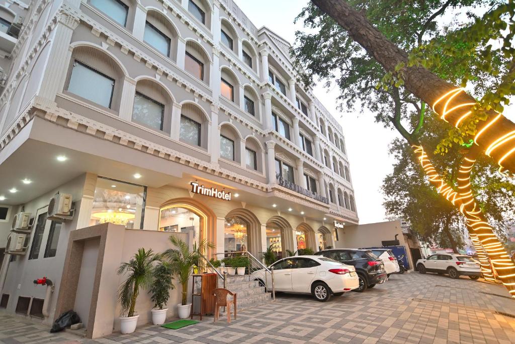 a building with cars parked in front of it at TrimHotel Grandview Jaipur in Jaipur