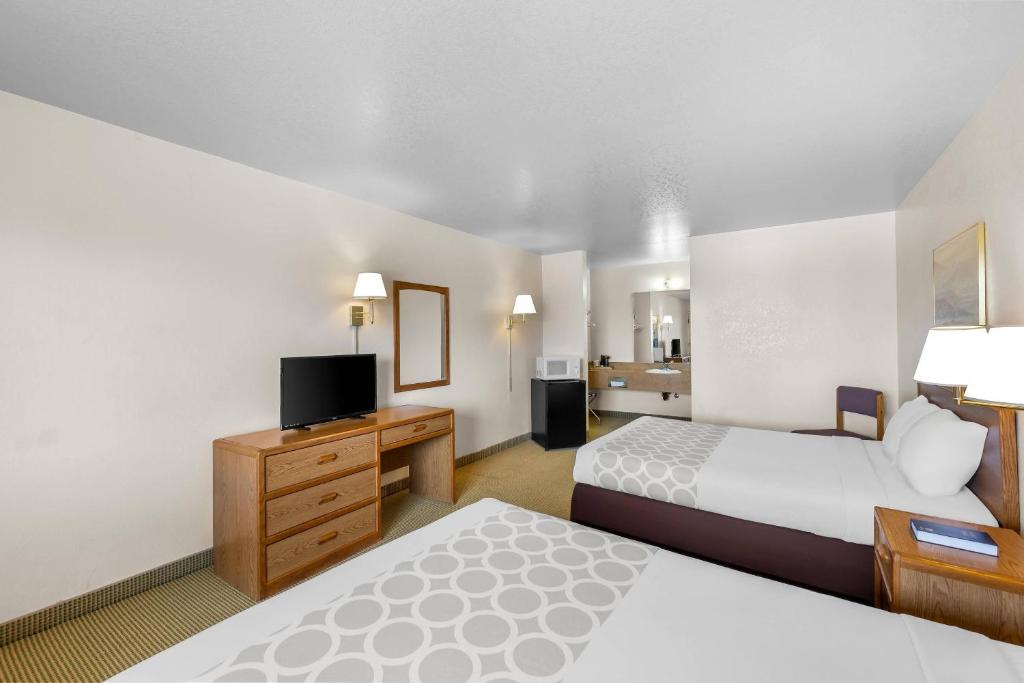 a hotel room with two beds and a flat screen tv at Rodeway Inn Copper Stay Benson AZ I-10 Exit 304 in Benson
