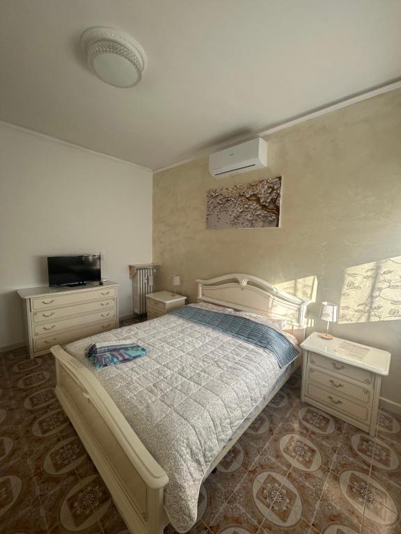 a bedroom with a bed and a television in it at Central City Apartment of Asti in Asti