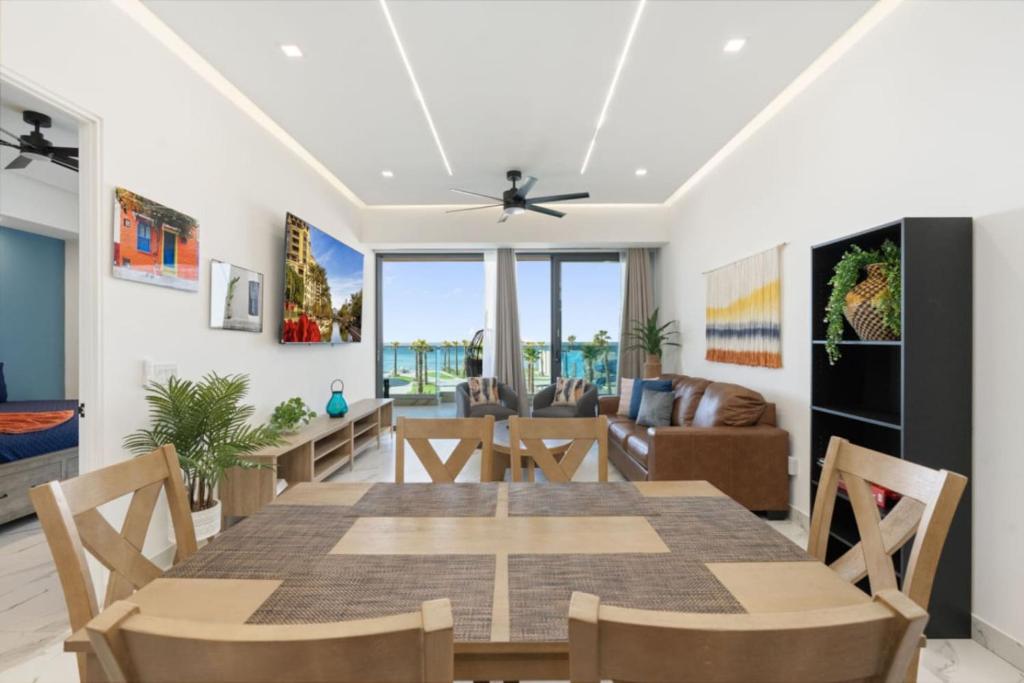 a dining room and living room with a table and chairs at Encantame Soleil 2nd floor 2Br Sleeps8 in Playa Encanto