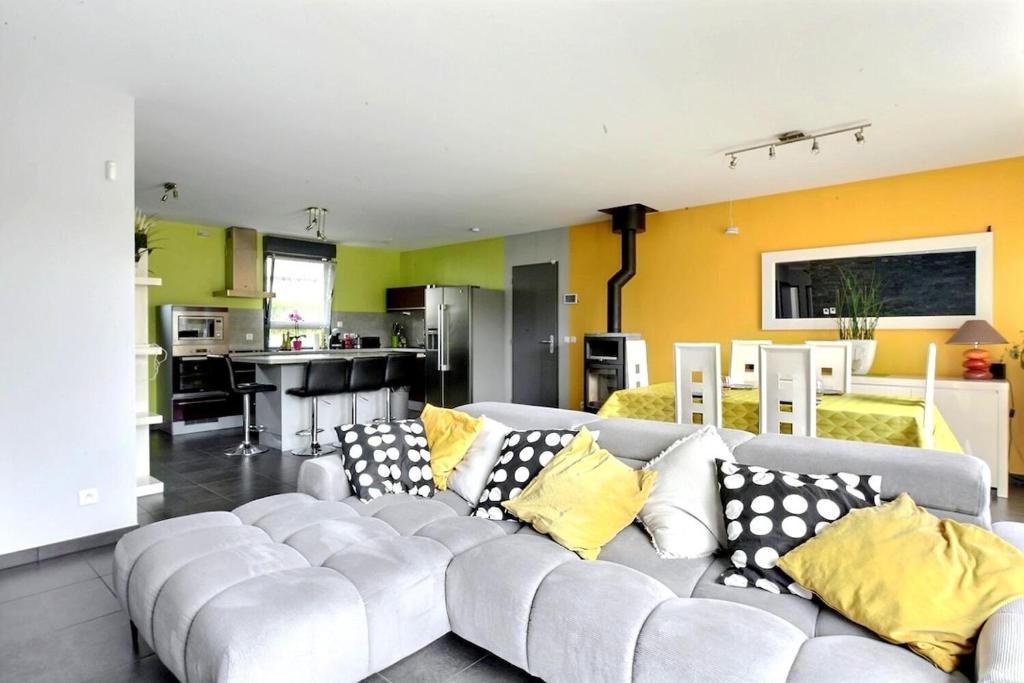 a living room with a white couch with yellow pillows at FAA'mily Home, 3 bedrooms, meublé de tourisme 4 étoiles in Offemont