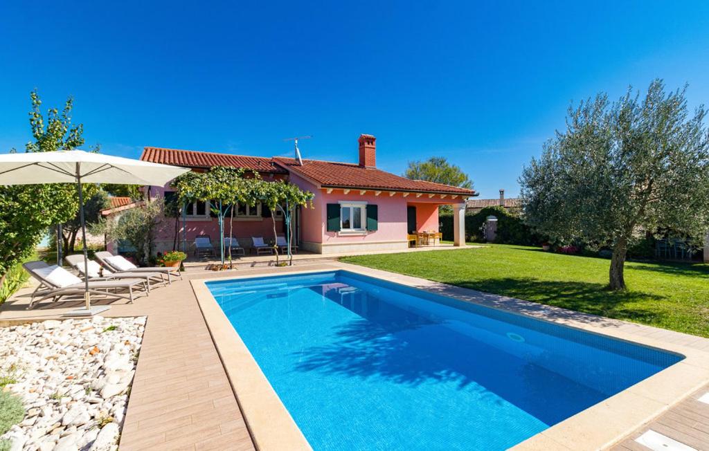 a swimming pool in front of a house at House Moreda by Istrialux in Vodnjan
