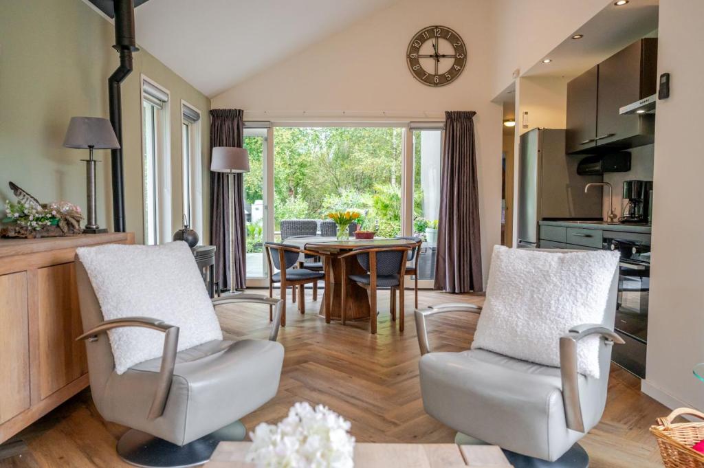 a kitchen and living room with a table and chairs at Charming Vacation Home Spier in Spier