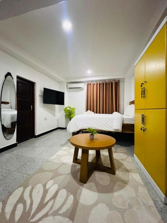 a hotel room with a bed and a table at Studio Room in Zanzibar City