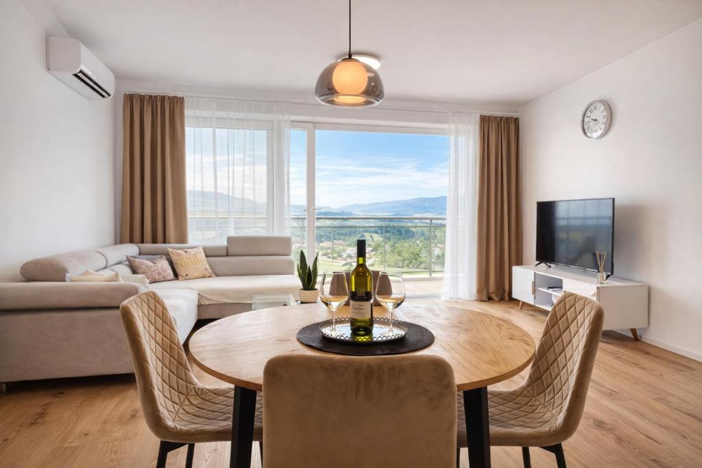 a living room with a table and a couch at Modern Smart Apartment, Garage & City View in Lipany