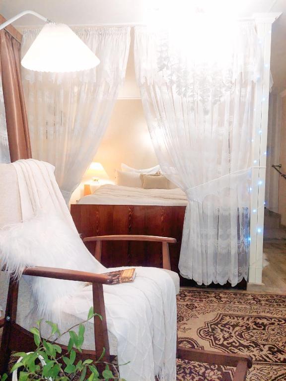 a bedroom with two beds and a window with curtains at Тиха гавань в чарівному містечку in Korsun'-Shevchenkivs'kyy