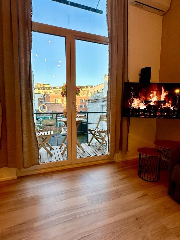 a large window with a view of a balcony at Luxury Suites Royal by Rikas Hotels in Antwerp