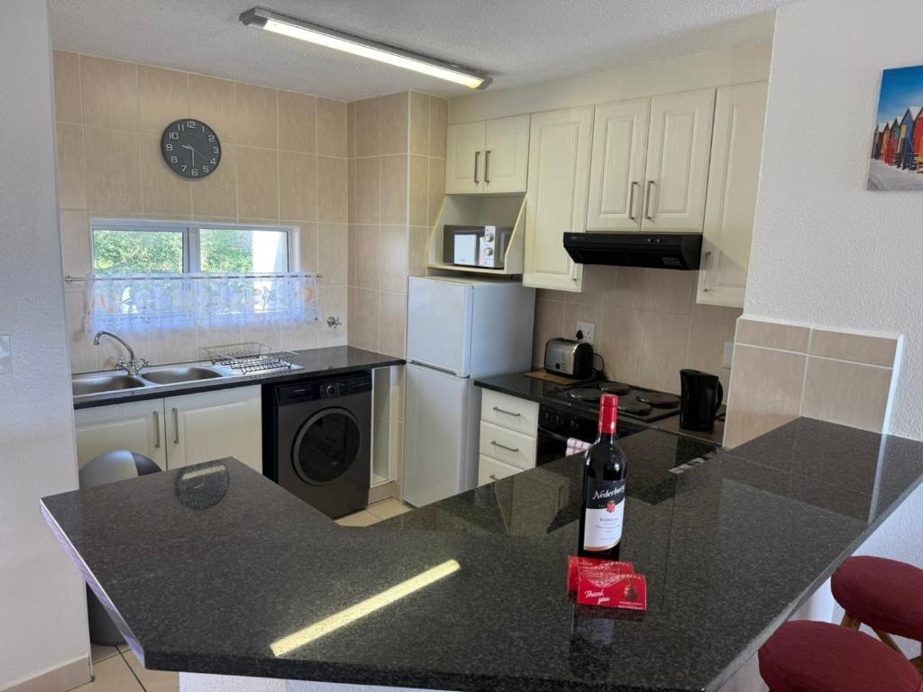 a kitchen with a bottle of wine on a counter at 222 Laguna La Crete in Margate