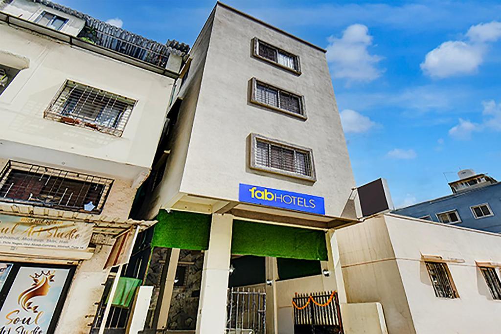 a building with a sign on the side of it at Via Pink House in Pune
