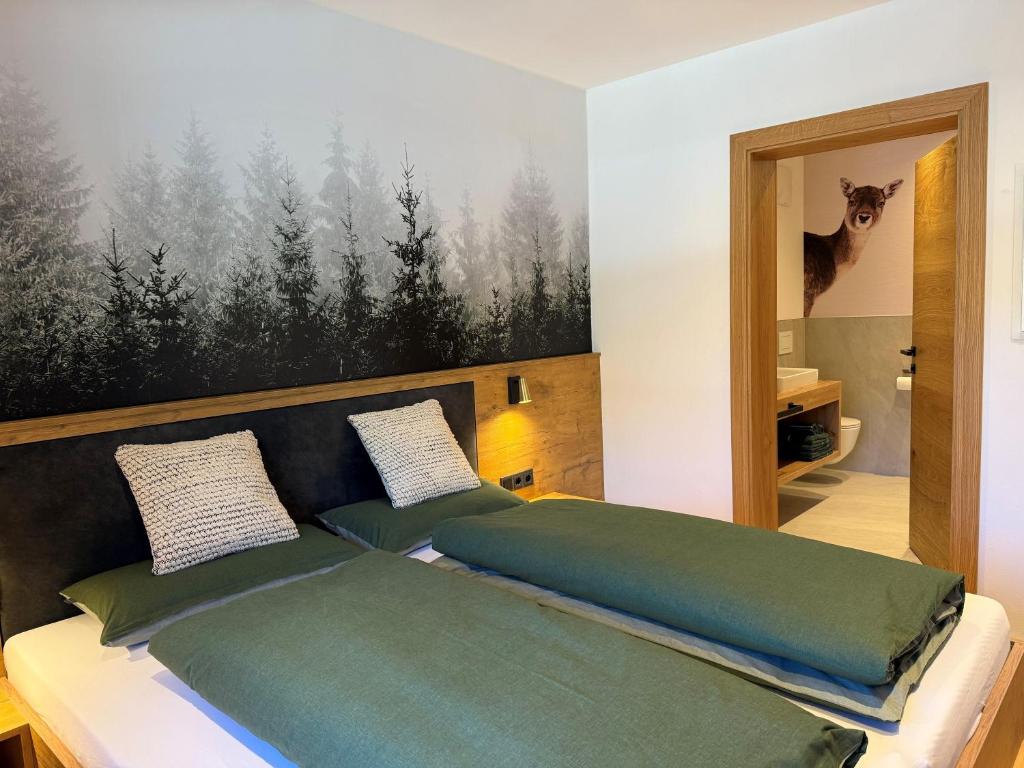a bed with two pillows on it in a room at Apartment Winkl 65 in Maria Alm am Steinernen Meer