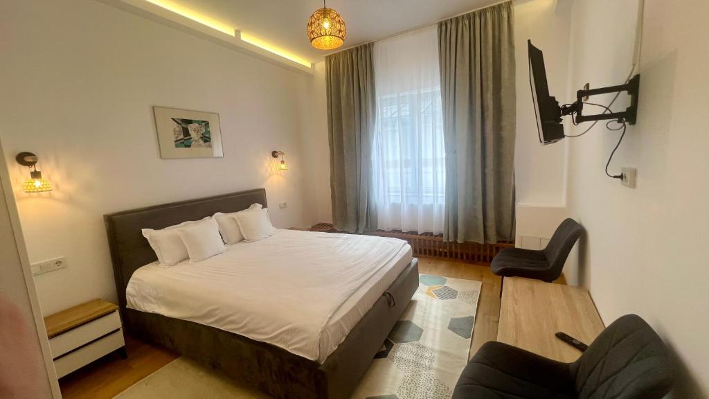 En eller flere senge i et værelse på Parc Vatra Dornei - Deluxe Suite