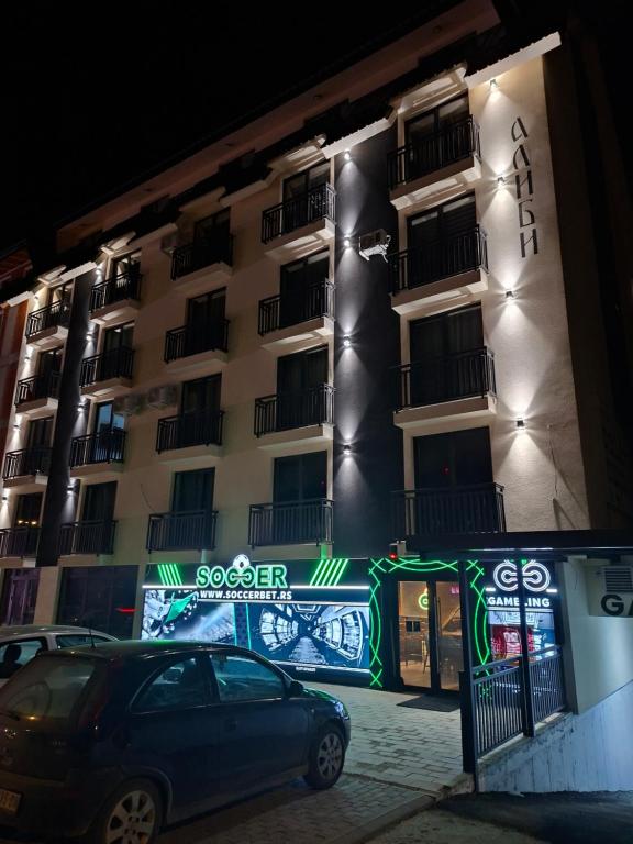 a car parked in front of a building at night at Vikvid in Kopaonik