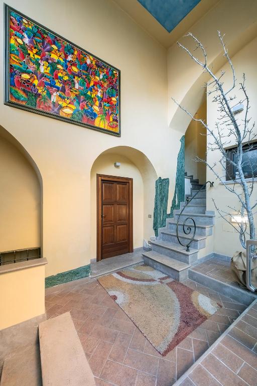 a living room with a large painting on the wall at Dimora Paradiso in Campobasso