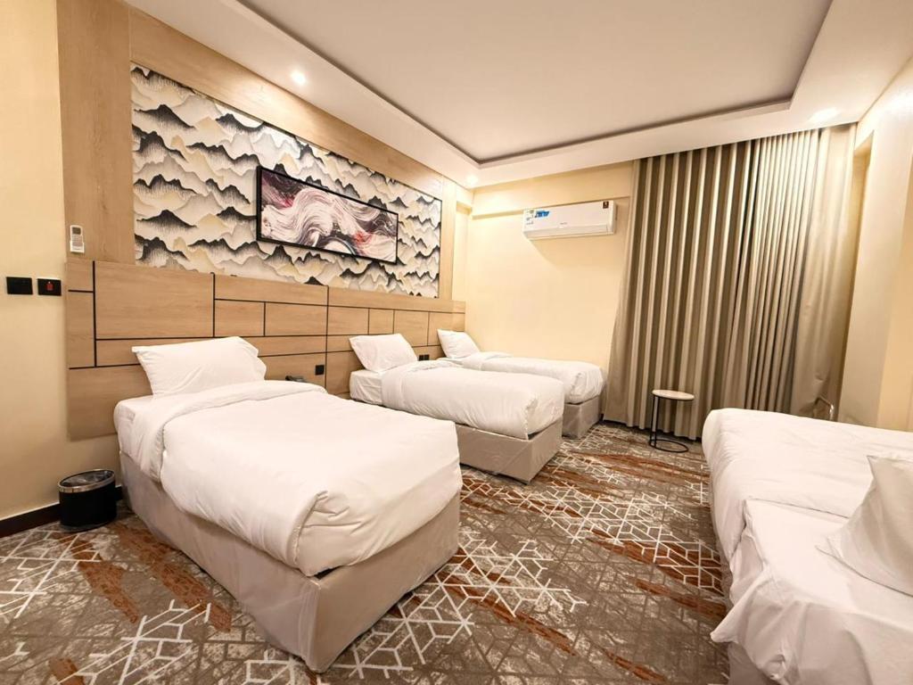 En eller flere senge i et værelse på نزل أجيال طيبة