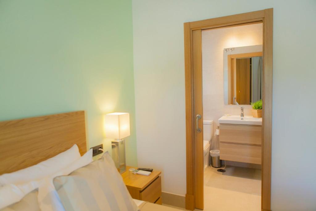 Postel nebo postele na pokoji v ubytování Hotel Novomar