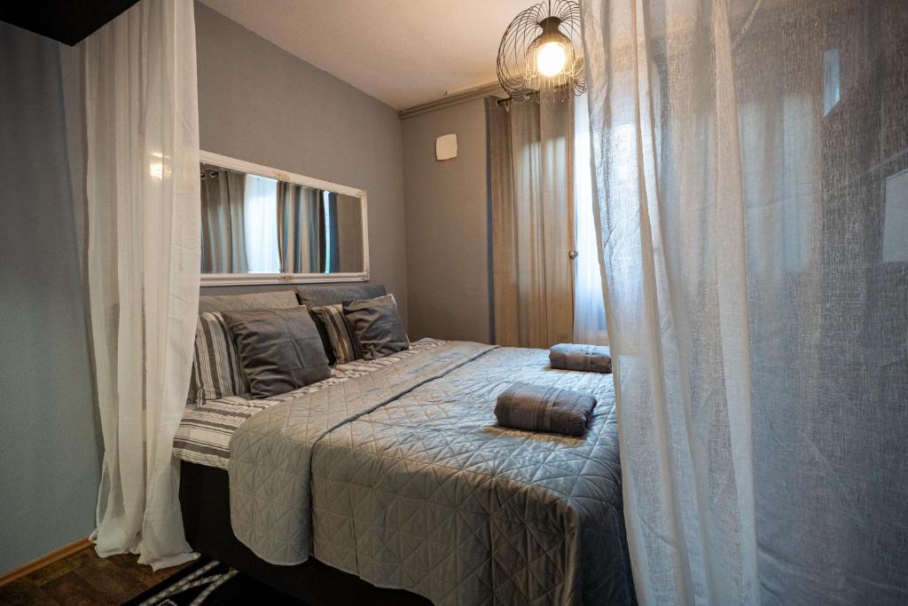 a bedroom with a bed with curtains and a window at Apartment Angel's Nest with Sauna and Fitness in Jesenice