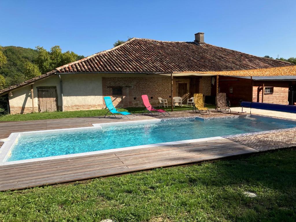 a swimming pool in front of a house at La maison de Laujol in Moissac