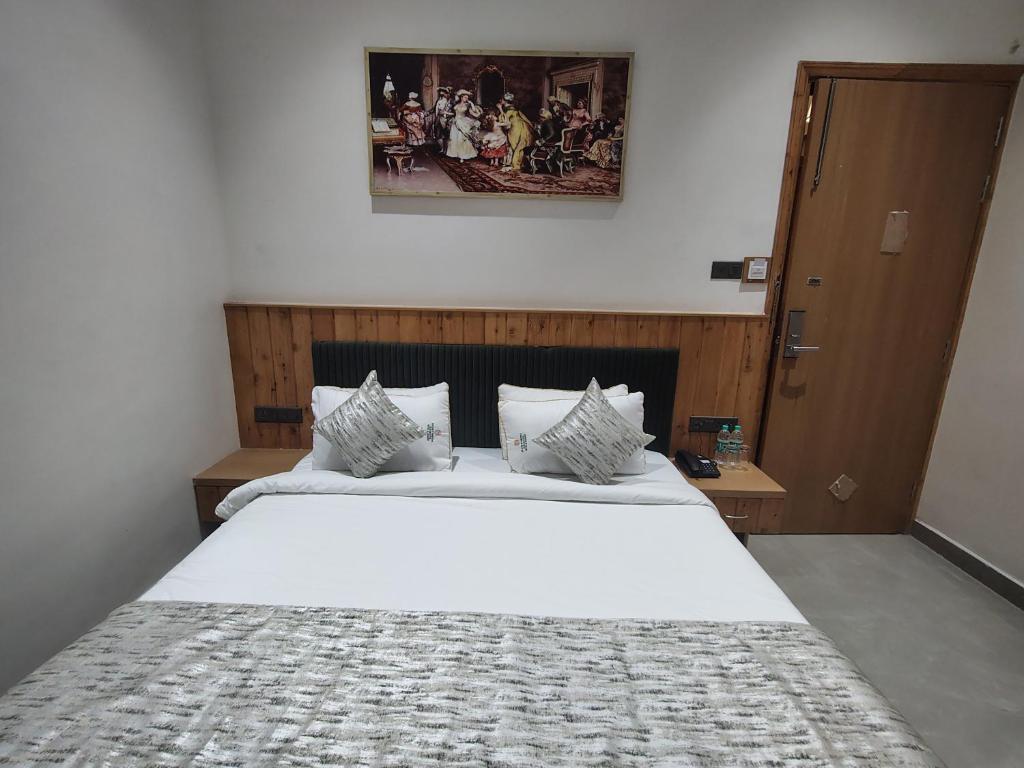 a bedroom with a large white bed in a room at Hotel Northern Heights in Amritsar