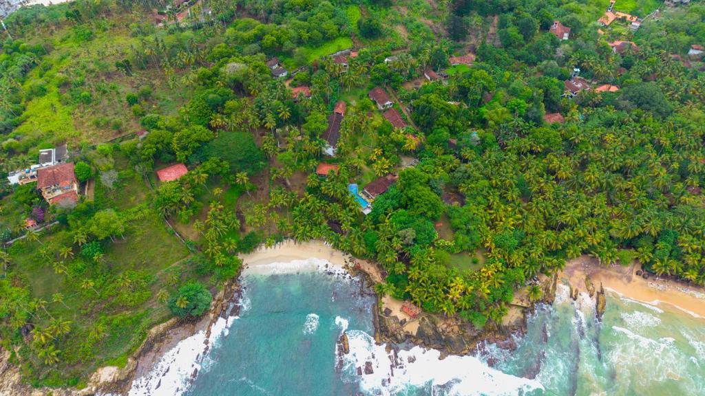 een luchtfoto van een strand en de oceaan bij Goyambokka Beach front pool resort in Tangalle