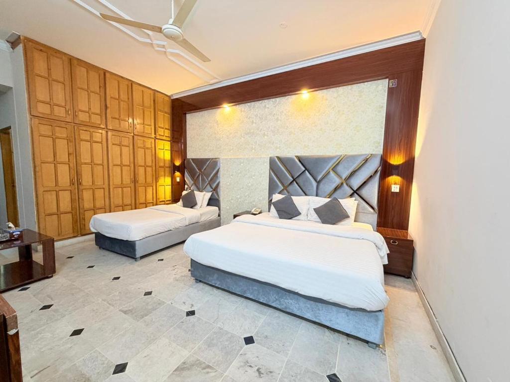 a bedroom with two beds in a room at Royal Continental in Islamabad