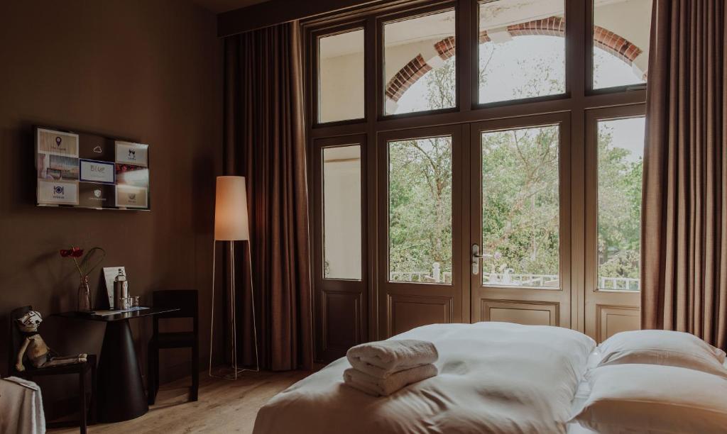 Ένα ή περισσότερα κρεβάτια σε δωμάτιο στο Boutique Hotel Blue - Quality Lodgings