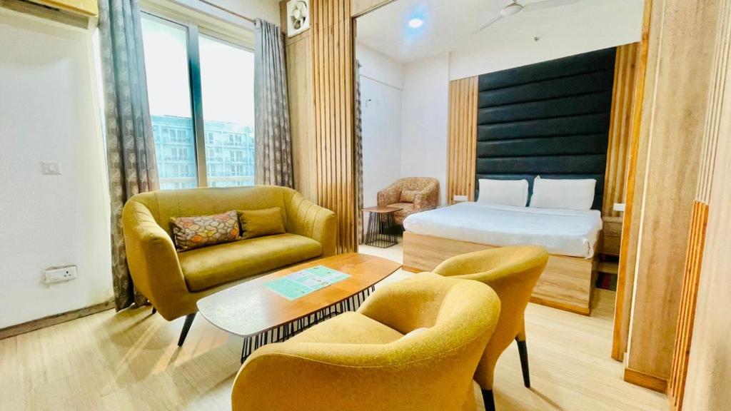 En eller flere senge i et værelse på The Grace Residency Lucknow