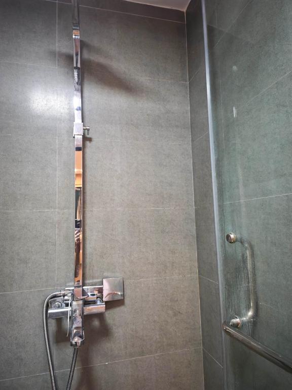 a shower with a glass door in a bathroom at J&J guest house in Hanoi