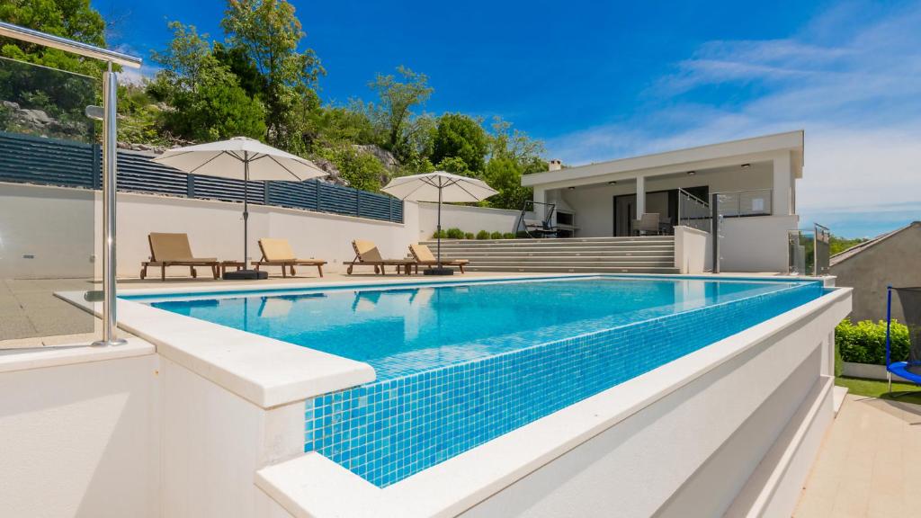 a swimming pool in the backyard of a house at Villa Rusula -Makarska by Villas Guide in Zagvozd