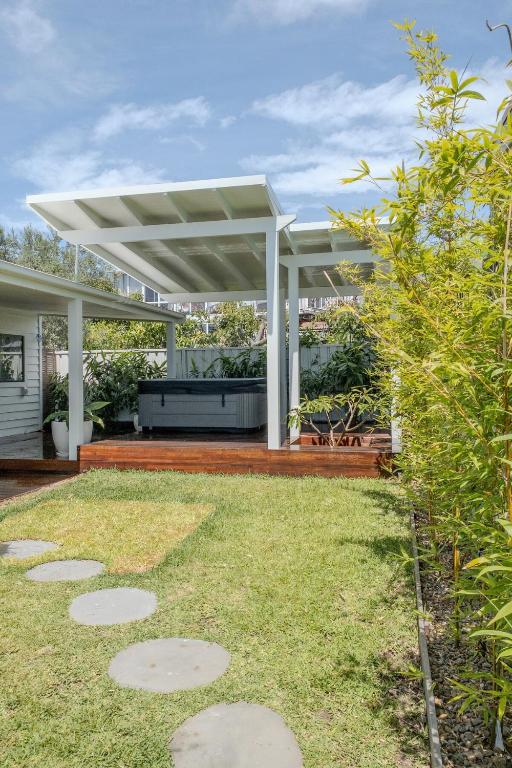 an outdoor patio with a white pergola at Studio11 - Vincentia in Vincentia
