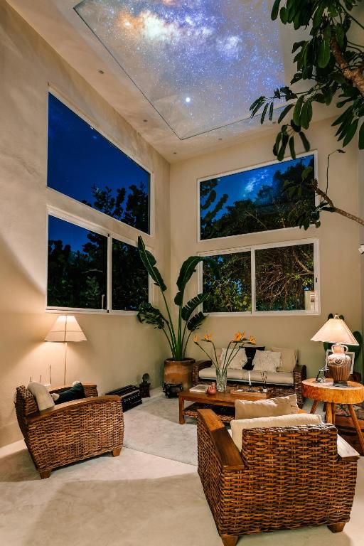 a living room with a ceiling with windows at Casa Rocka Boutique Breakfast & Beach Club included in Isla Mujeres