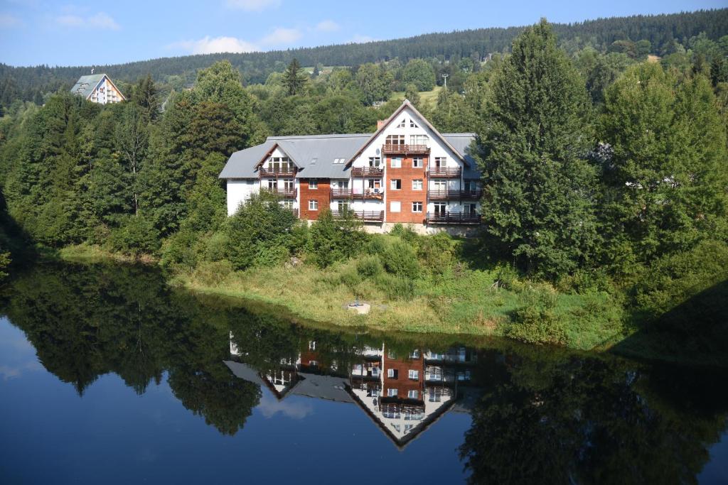 an aerial view of a house on an island in the water at Apartment Spindleruv Mlyn Labska in Špindlerův Mlýn